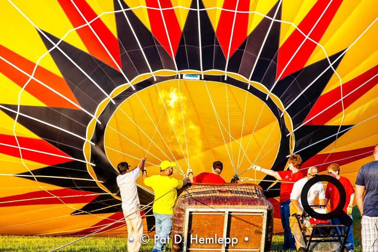 A crew inflates the canopy of a hot-air balloon during a festival in Grove City, Ohio.
